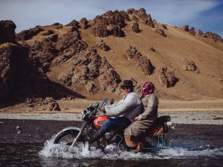 Crossing a river on a motorbike in Mongolia