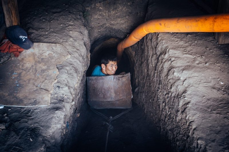 Worker inside a narrow underground coal tunnel in Mongolia.