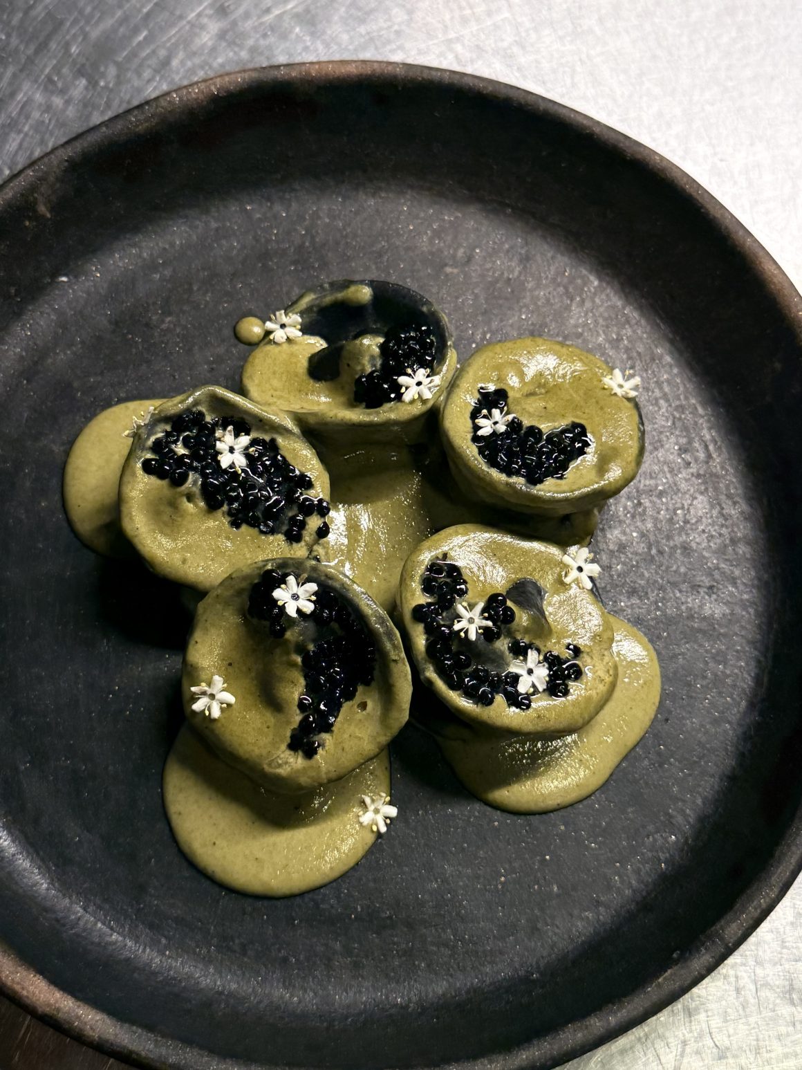 Sliced octopus with capers and herb dressing at Canopia
