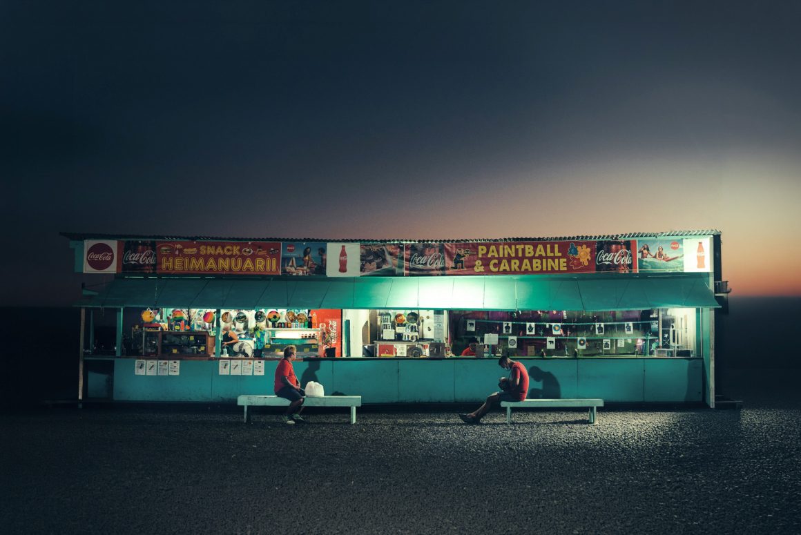 Roadside snack and games stand illuminated after sunset in French Polynesia. Photo by Hélène Havard.