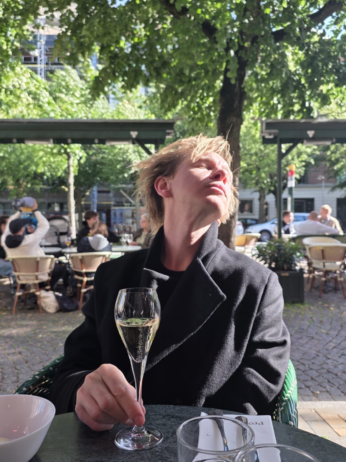 Localsinsider enjoying a glass of sparkling wine at an outdoor café thanks to swirl app